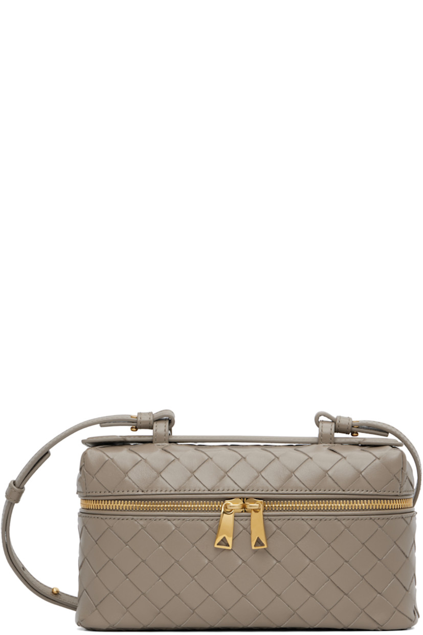 Intrecciato-woven grained calfskin top handle bag.

· Fixed carry handle
· Adjustable and detachable crossbody strap
· Two-way zip closure
· Card slot at interior
· H5" x W9" x D2.5"

Supplier color: Limestone