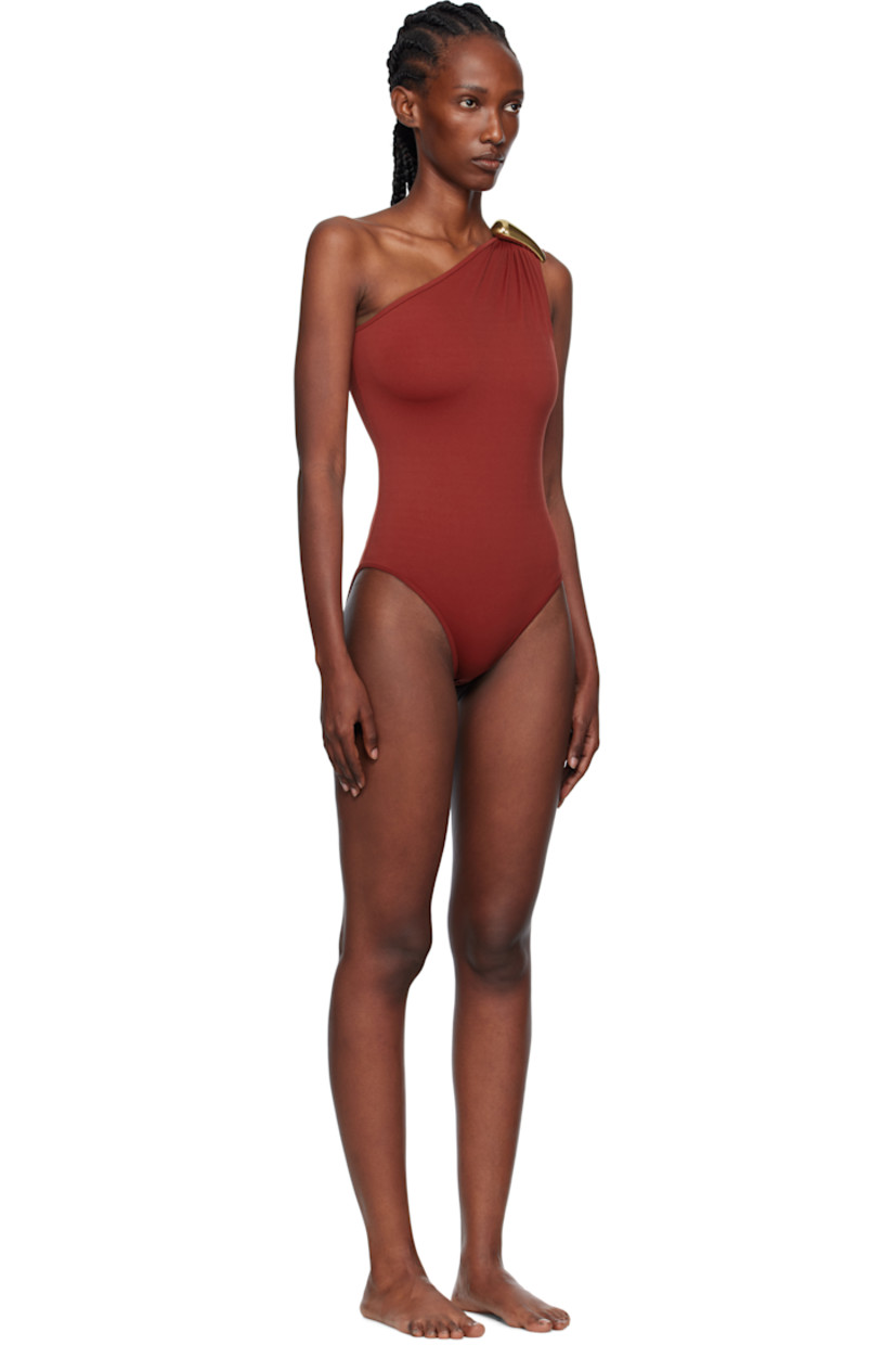 Stretch nylon one-piece swimsuit.

· Single-shoulder construction
· Sculptural hardware at shoulder
· Partially lined

Supplier color: Lava