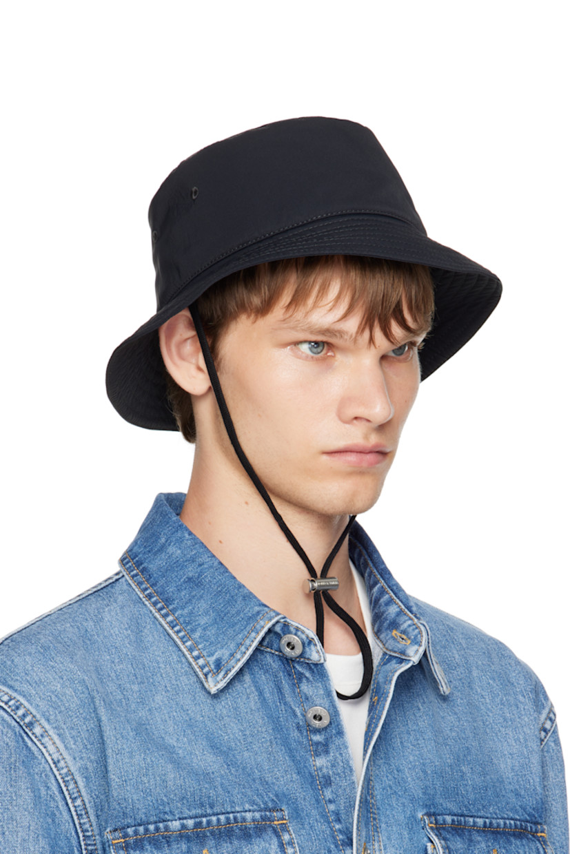 Nylon taffeta bucket hat.

· Quilted brim
· Embroidered eyelets at sides
· Cord-lock chin strap
· Cotton twill lining

Supplier color: Black