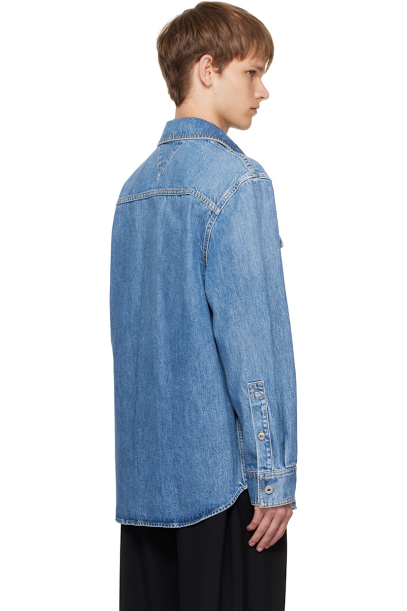 Non-stretch denim shirt.

· Fading throughout
· Spread collar
· Button closure
· Flap pockets at chest
· Shirttail hem
· Buttoned barrel cuffs
· Contrast stitching in tan

Supplier color: Blue