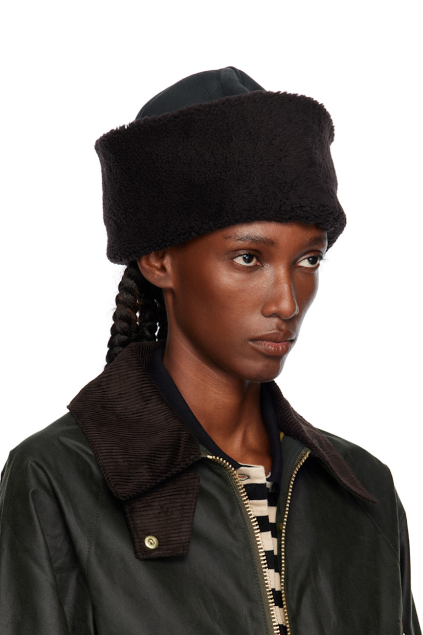 Grained lambskin hat. Shearling rolled brim and interior.

Supplier color: Dark brown aviator shearling