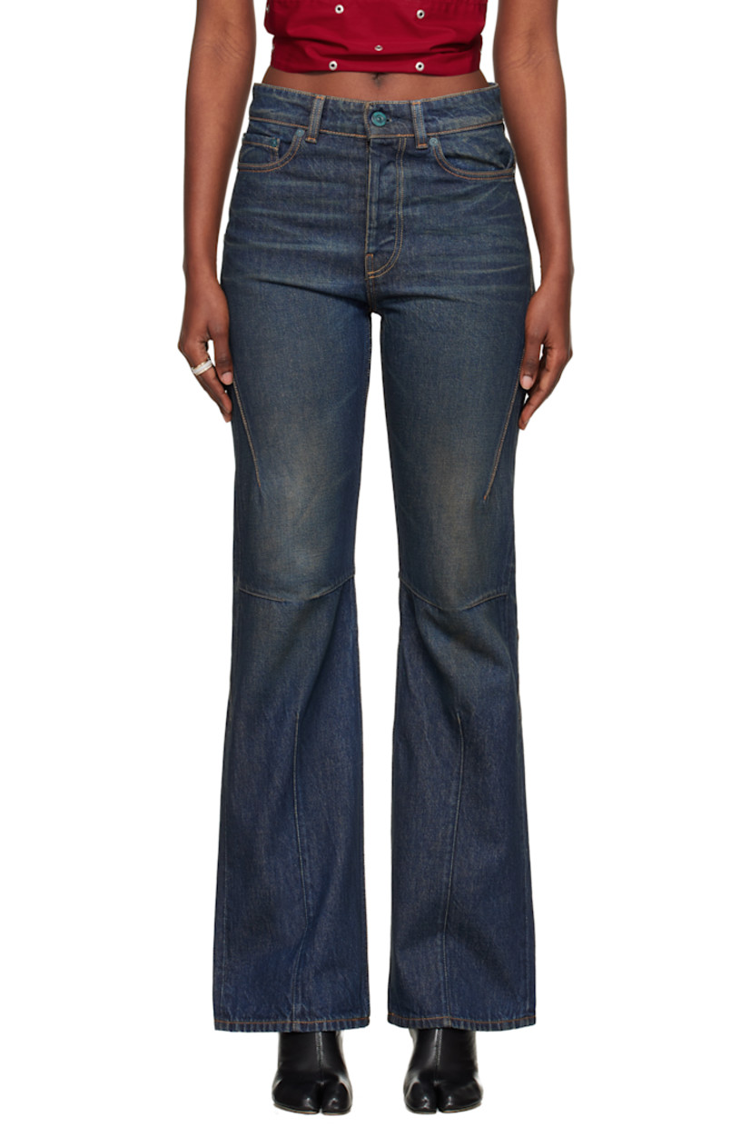 Non-stretch denim jeans.

· Fading, whiskering, and darts throughout
· Flares at knee
· Mid-rise
· Belt loops
· Five-pocket styling
· Zip fly
· Contrast stitching in tan

Supplier color: Sand tint