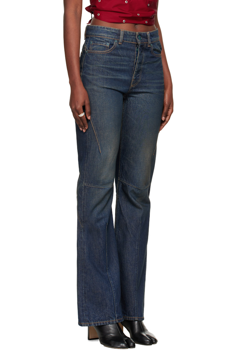 Non-stretch denim jeans.

· Fading, whiskering, and darts throughout
· Flares at knee
· Mid-rise
· Belt loops
· Five-pocket styling
· Zip fly
· Contrast stitching in tan

Supplier color: Sand tint
