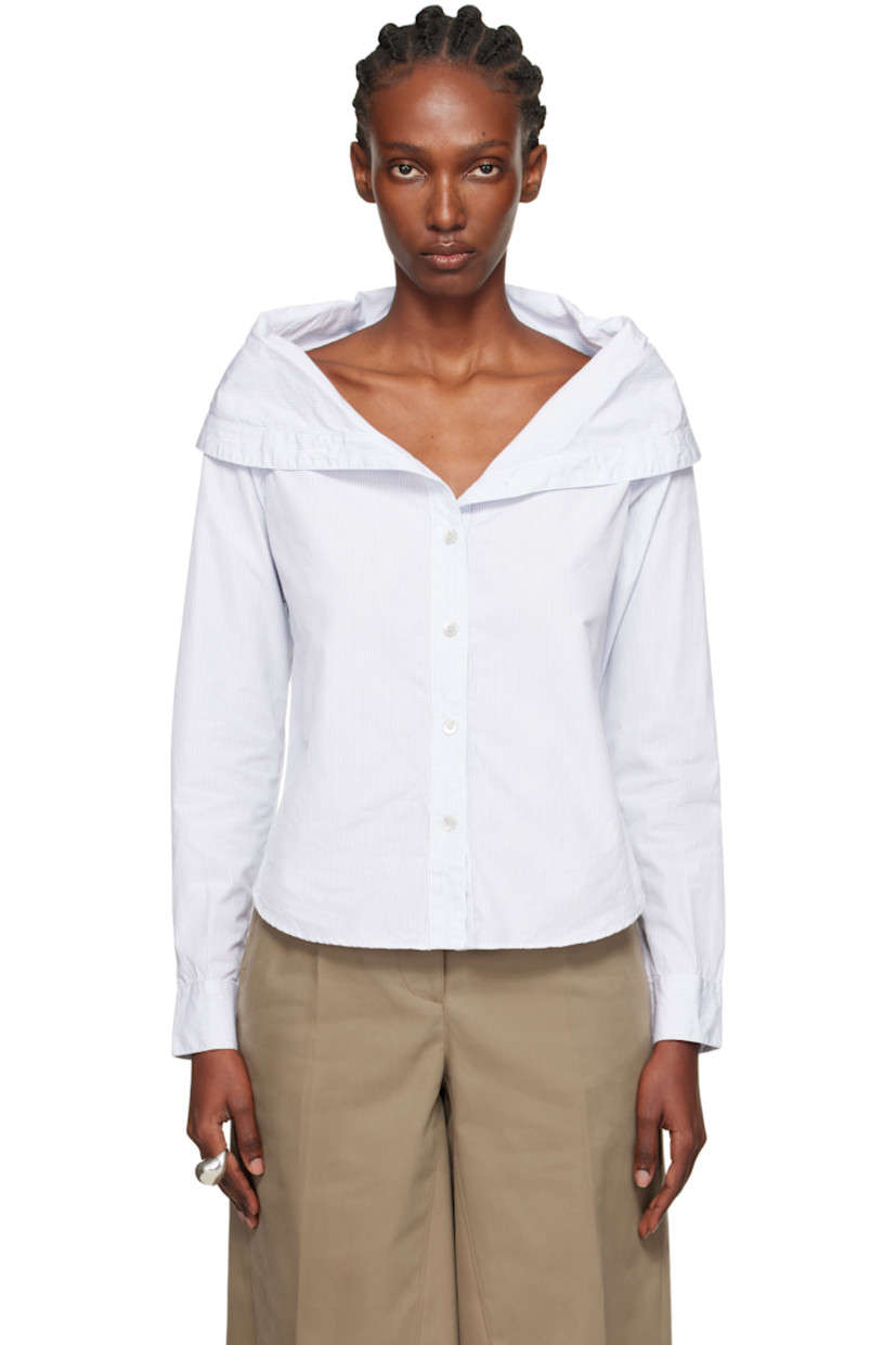 Cotton poplin shirt.

· Stripes throughout
· Foldover boat neck
· Button closure
· Shirttail hem
· Buttoned barrel cuffs
· Mother-of-pearl hardware

Supplier color: Diner pinstripe super poplin