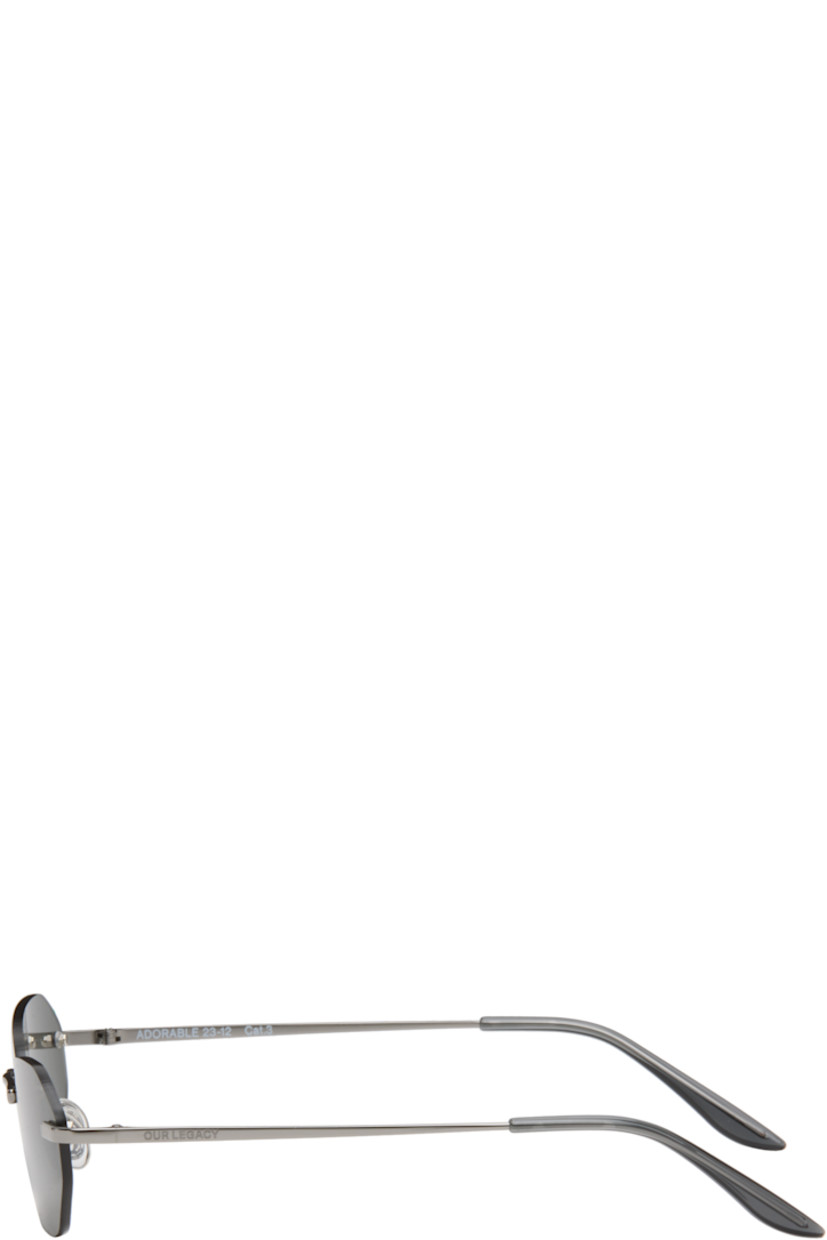 Oval rimless metal-frame sunglasses.

· Black Carl Zeiss lenses, cat. 3
· Adjustable nose pads
· Logo etched at single temple
· Acetate temple tips
· Hinged leather case included

Supplier color: Trinity Black