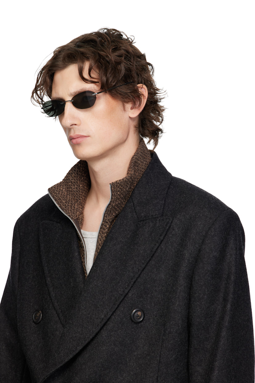 Oval rimless metal-frame sunglasses.

· Black Carl Zeiss lenses, cat. 3
· Adjustable nose pads
· Logo etched at single temple
· Acetate temple tips
· Hinged leather case included

Supplier color: Trinity Black