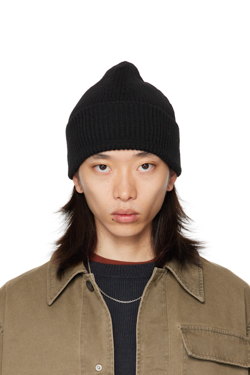 Rib-knit merino wool beanie. Rolled brim.

Supplier color: Black rustic merino