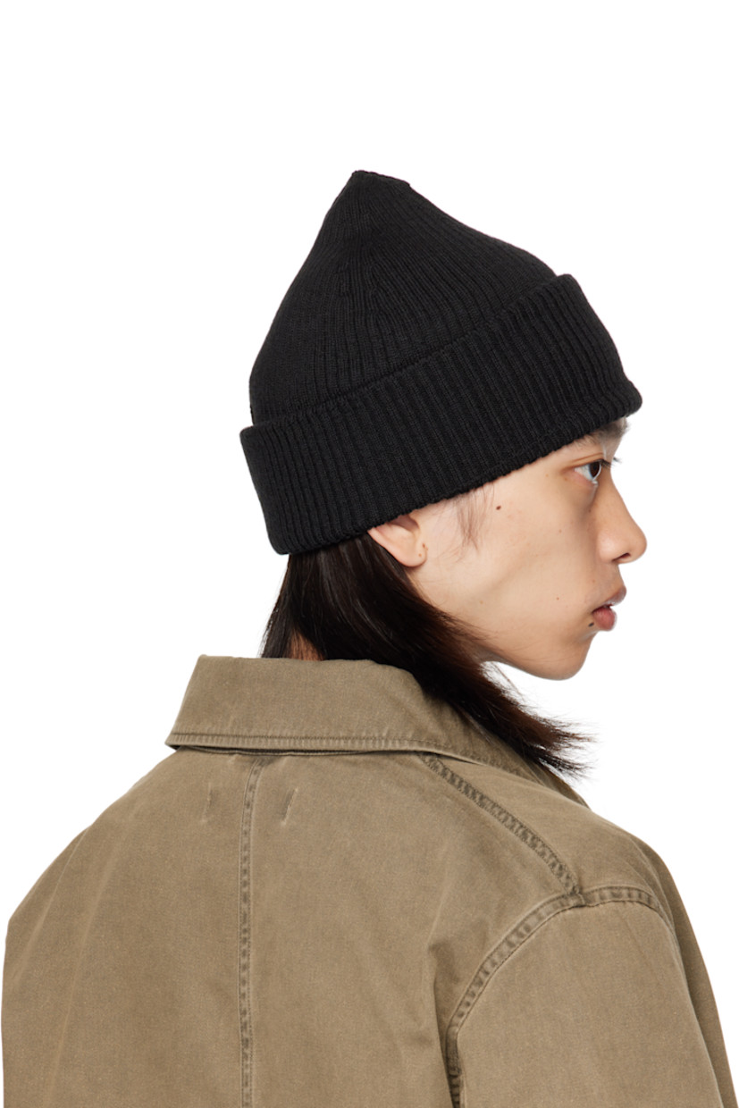 Rib-knit merino wool beanie. Rolled brim.

Supplier color: Black rustic merino