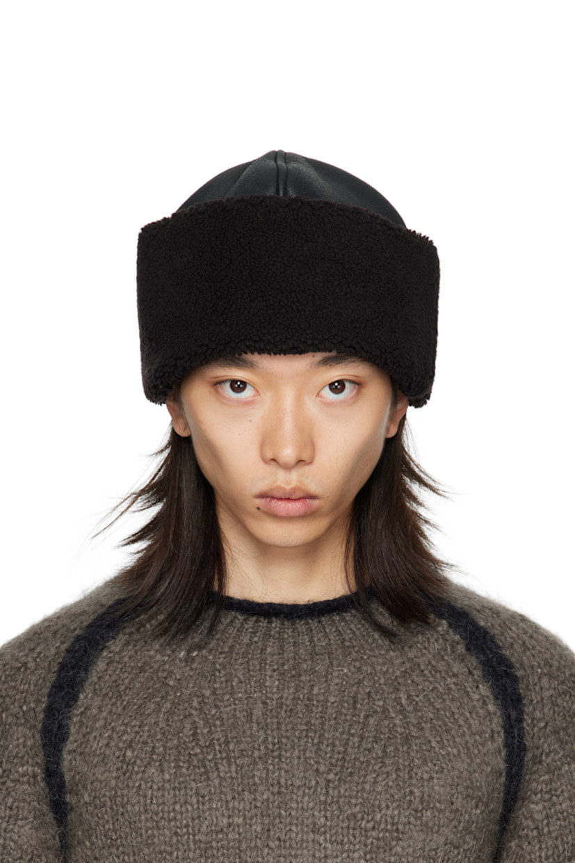 Grained lambskin hat. Shearling trim at rolled brim.

Supplier color: Dark brown aviator