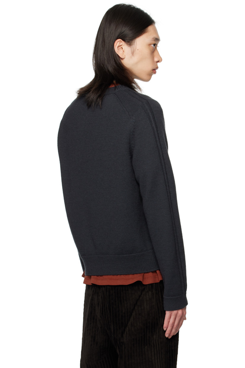 Knit wool sweater. 

· Rib-knit round neck, hem, and cuffs
· Saddle shoulders
· Drop stitch detailing at sleeves 

Supplier color: Off black rustic merino