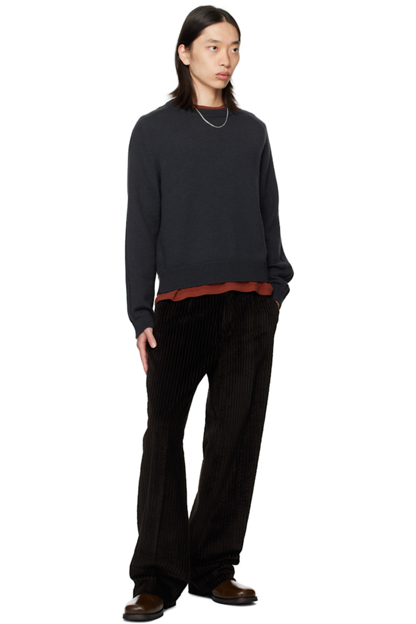 Knit wool sweater. 

· Rib-knit round neck, hem, and cuffs
· Saddle shoulders
· Drop stitch detailing at sleeves 

Supplier color: Off black rustic merino