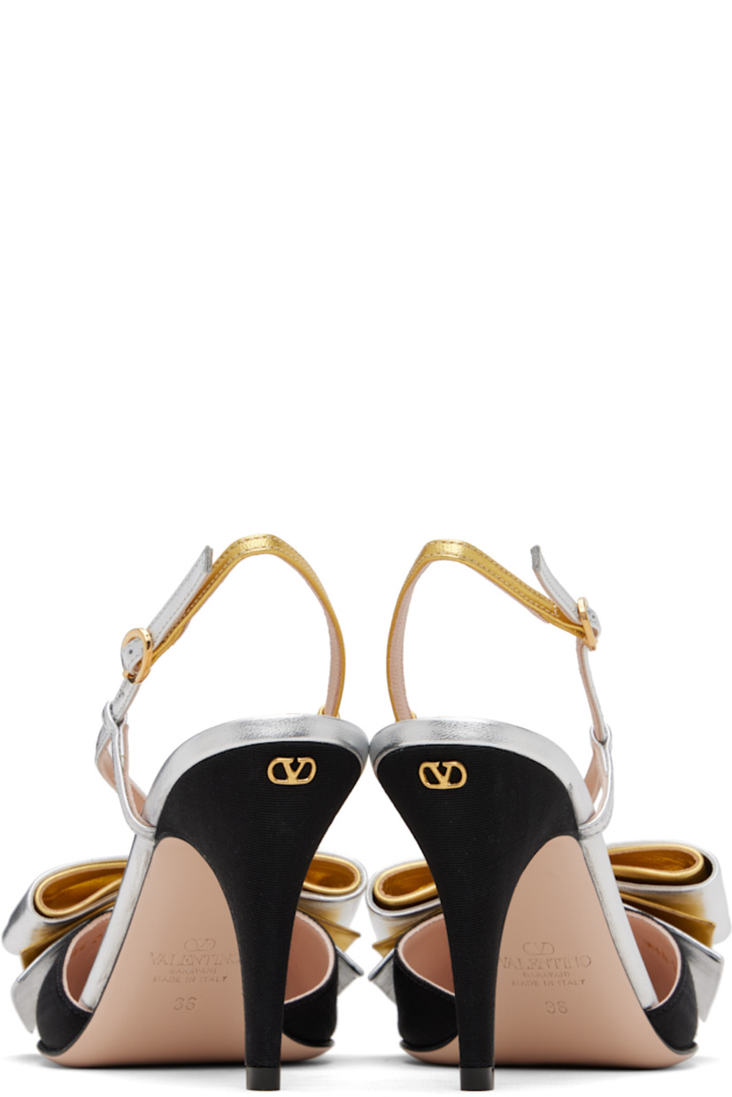 Moiré and grained nappa sheepskin heels. 

· Pointed toe 
· Cutout and layered bow accents at vamp 
· Crisscrossing straps 
· Pin-buckle slingback strap
· Logo and graphic at footbed
· Logo hardware at heel 
· Covered stiletto heel with rubber injection
· Leather sole 
· Gold-tone hardware
· Heel: H3.5"

Supplier color: Black/Silver/Antique gold