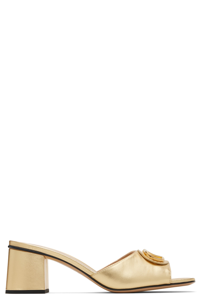 Grained calfskin heeled sandals.

· Open square toe 
· Strap and logo hardware at vamp
· Logo printed at footbed
· Covered block heel with rubber injection
· Leather sole 
· Gold-tone hardware 
· Heel: H2.5"

Supplier color: Antique brass li