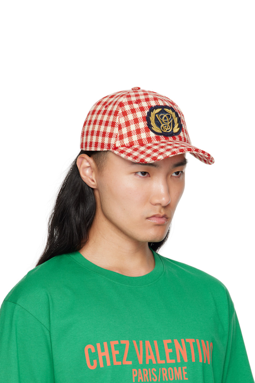 Cotton- and virgin wool-blend tweed cap.

· Check pattern throughout
· Embroidered eyelets at crown
· Embroidered logo patch at face
· Curved brim
· Cinch fastening
· Plain-woven lining

Supplier color: Red/Ivory
