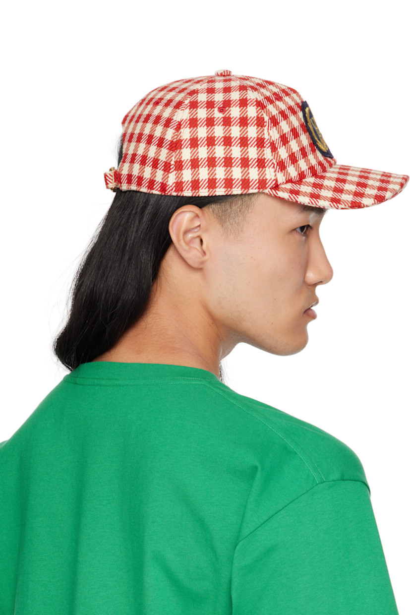 Cotton- and virgin wool-blend tweed cap.

· Check pattern throughout
· Embroidered eyelets at crown
· Embroidered logo patch at face
· Curved brim
· Cinch fastening
· Plain-woven lining

Supplier color: Red/Ivory