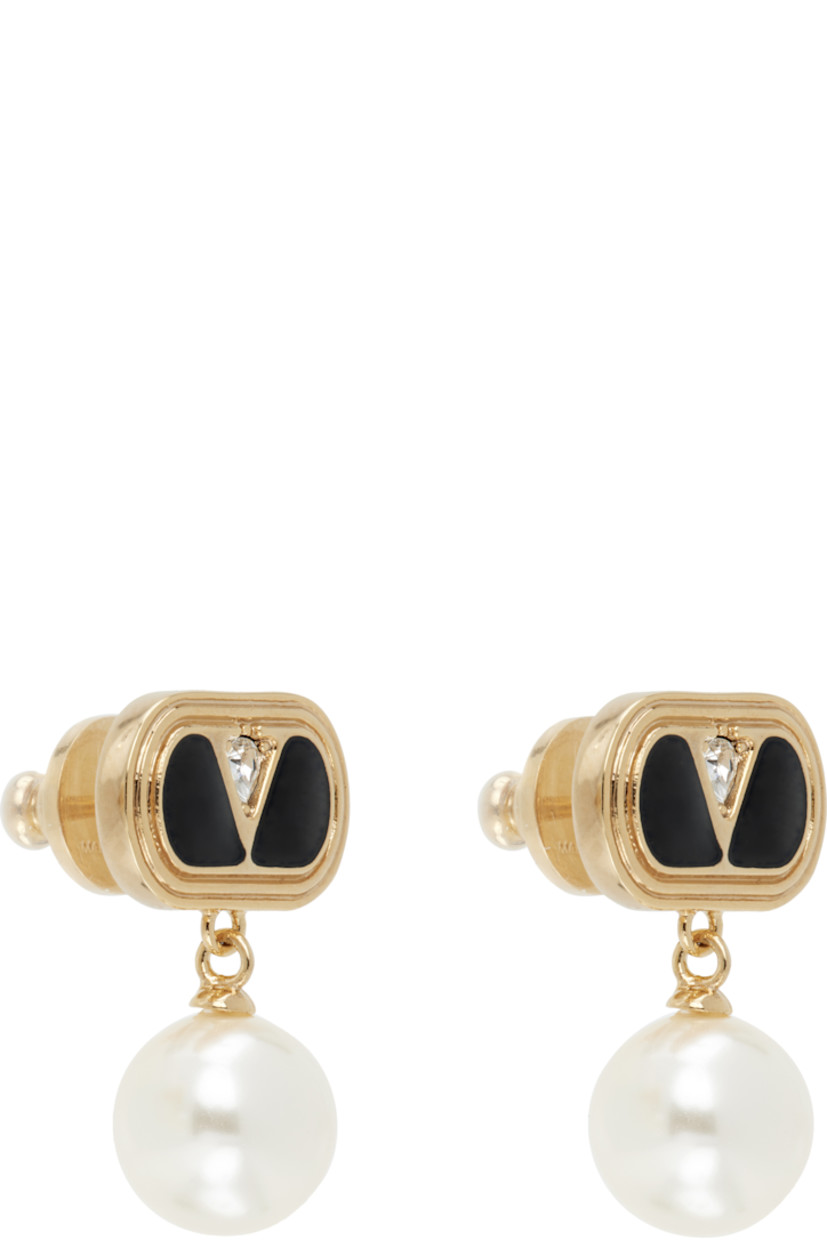 Pair of drop earrings in gold tone.

· Logo hardware, black enamel, and crystal at face
· Swarovski pearl at drop
· Post-stud fastening 
· H1" x W0.5"

Supplier color: Gold/Black