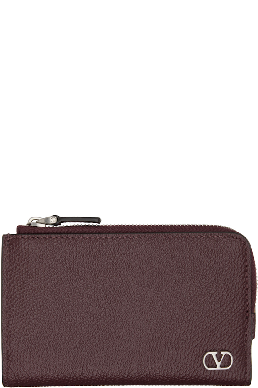 Pebble-grained calfskin wallet.

· Logo hardware and zip coin compartment at face
· Press-stud closure
· Eight card slots at interior 
· Two patch pockets and one note slot
· Canvas lining 
· Silver-tone hardware 
· H3.25" x W5" x D0.75"

Supplier color: Rosewood