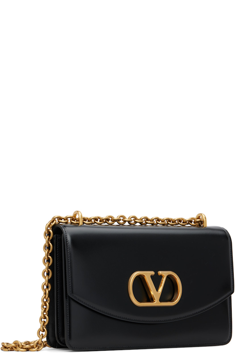 Buffed calfskin messenger bag.

· Sliding cable chain crossbody strap
· Logo hardware at face
· Magnetic press-stud flap
· Zip pocket and card slot at two-compartment interior 
· Leather lining
· Gold-tone hardware
· H6.5" x W9.5" x D3"

Supplier color: Nero
