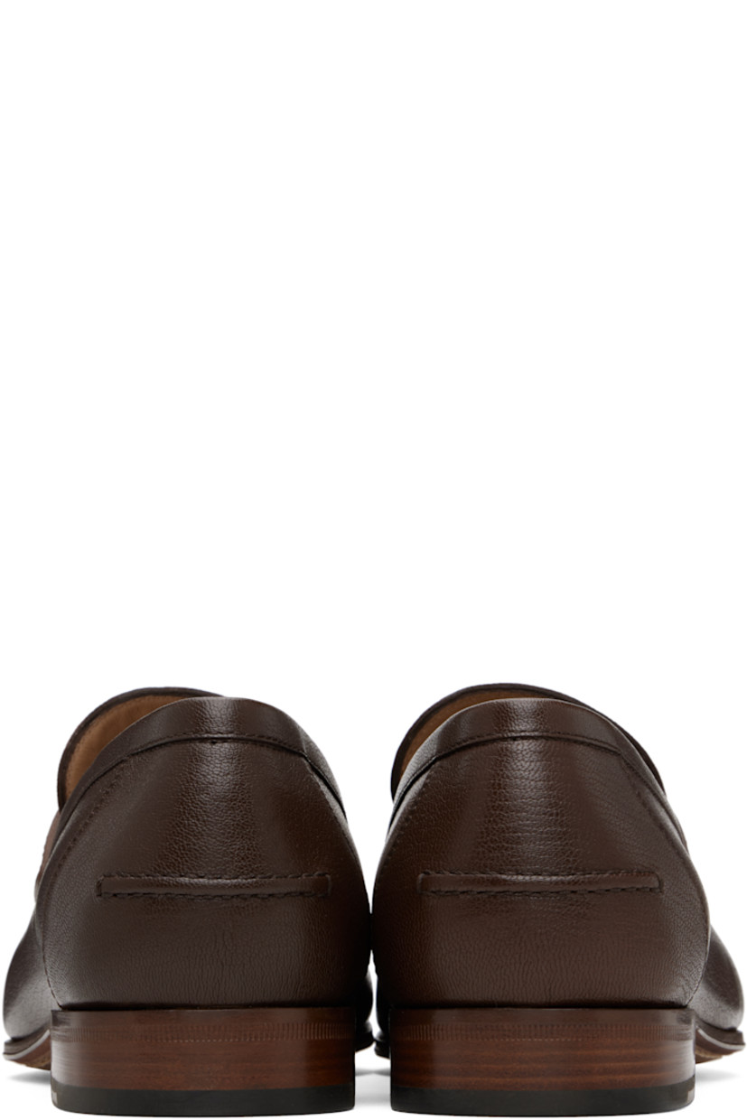Grained kidskin loafers.

· Moc toe
· Curb chain with logo hardware at vamp
· Pinched seam at heel counter
· Buffed leather lining
· Stacked leather heel with rubber injection
· Leather sole

Supplier color: Bark brown