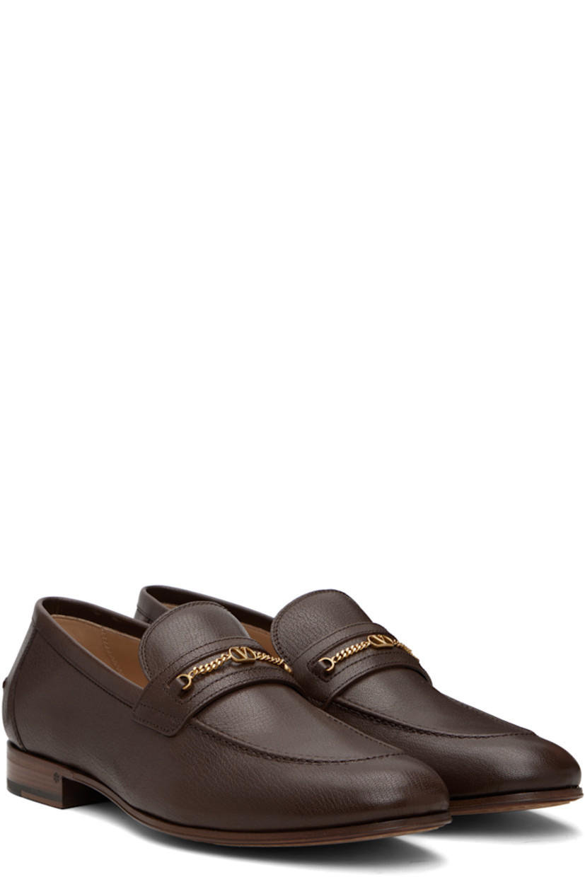 Grained kidskin loafers.

· Moc toe
· Curb chain with logo hardware at vamp
· Pinched seam at heel counter
· Buffed leather lining
· Stacked leather heel with rubber injection
· Leather sole

Supplier color: Bark brown