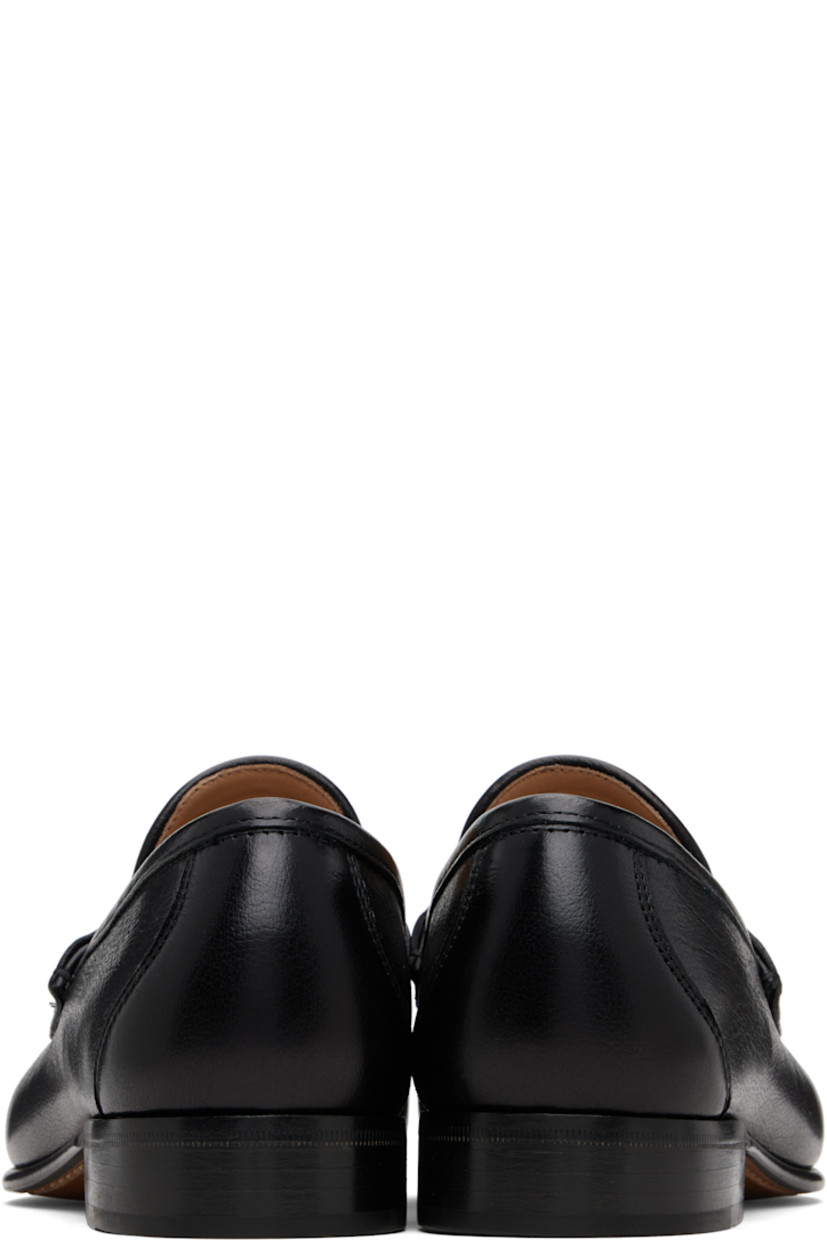 Grained buffalo leather loafers.

· Moc toe
· Strap and logo hardware at vamp
· Suede and buffed leather lining
· Stacked leather heel with rubber injection
· Leather sole
· Brass-tone hardware

Supplier color: Black