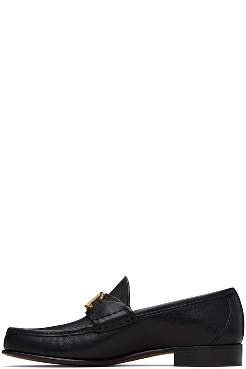 Grained buffalo leather loafers.

· Moc toe
· Strap and logo hardware at vamp
· Suede and buffed leather lining
· Stacked leather heel with rubber injection
· Leather sole
· Brass-tone hardware

Supplier color: Black