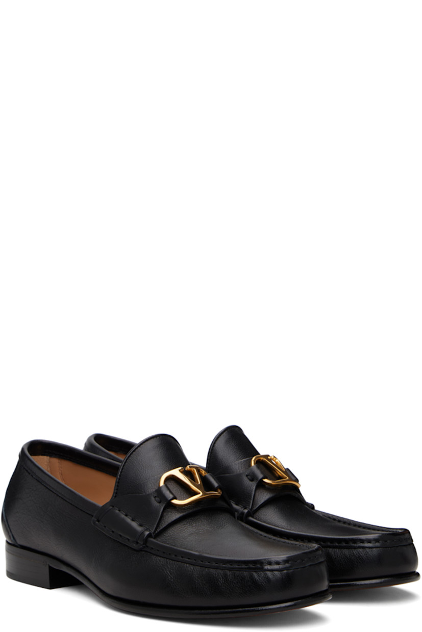 Grained buffalo leather loafers.

· Moc toe
· Strap and logo hardware at vamp
· Suede and buffed leather lining
· Stacked leather heel with rubber injection
· Leather sole
· Brass-tone hardware

Supplier color: Black
