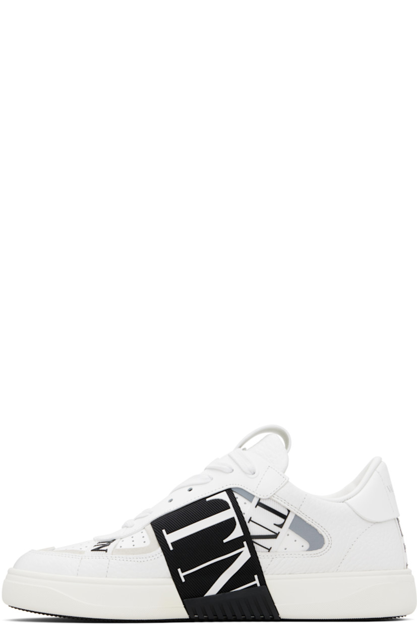 Low-top grained and buffed calfskin sneakers.

· Logo-bonded webbing trim throughout
· Calfskin suede trim at toe
· Perforations at toe and sides
· Lace-up closure
· Logo-stamped pull-loop at padded tongue
· Padded collar
· Reflective trim at sides
· Logo stamp at heel tab
· Bonded logo at heel counter
· Treaded rubber sole

Supplier color: White/Gray/Black