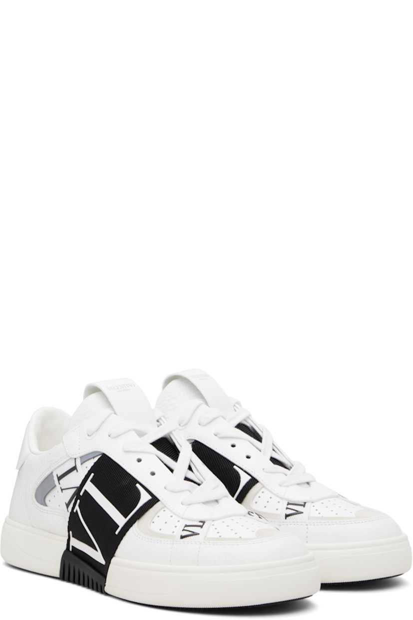 Low-top grained and buffed calfskin sneakers.

· Logo-bonded webbing trim throughout
· Calfskin suede trim at toe
· Perforations at toe and sides
· Lace-up closure
· Logo-stamped pull-loop at padded tongue
· Padded collar
· Reflective trim at sides
· Logo stamp at heel tab
· Bonded logo at heel counter
· Treaded rubber sole

Supplier color: White/Gray/Black
