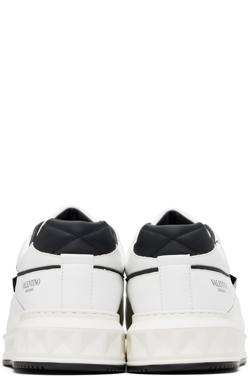 Low-top quilted nappa leather sneakers.

· Perforations at toe
· Lace-up closure
· Logo printed at padded tongue
· Padded collar
· Logo printed at outer side
· Signature pyramid stud at outer side
· Buffed leather and mesh lining
· Logo embossed at treaded rubber sole

Supplier color: White/Black/Grey