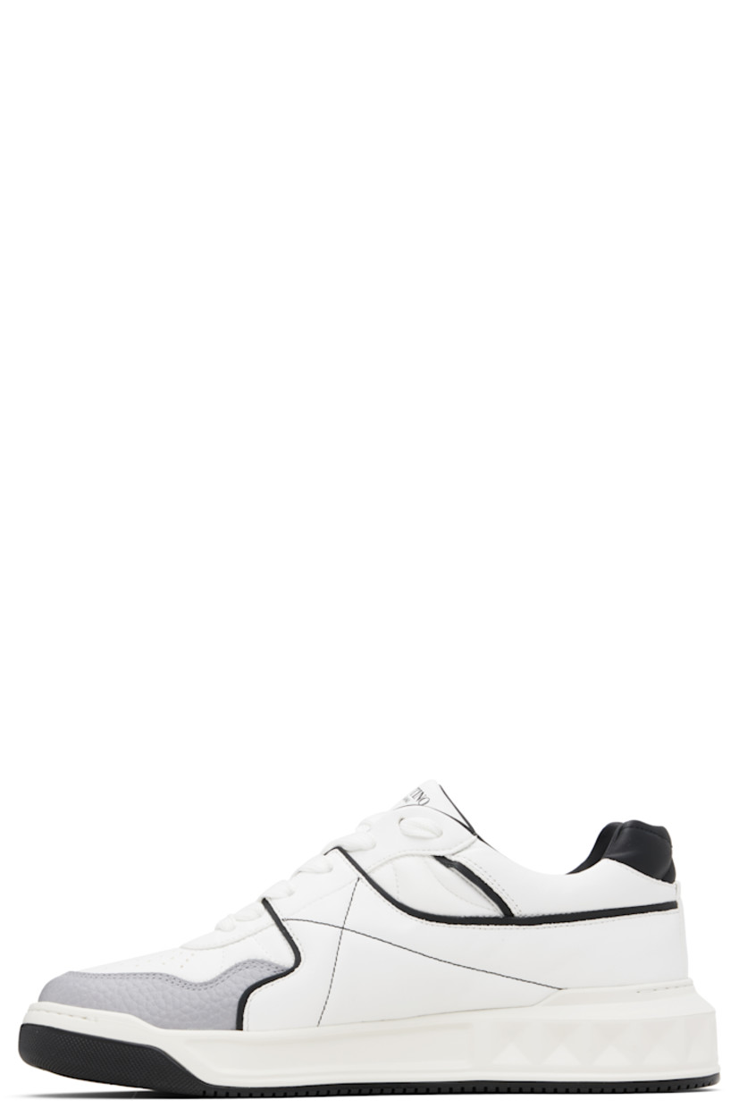 Low-top quilted nappa leather sneakers.

· Perforations at toe
· Lace-up closure
· Logo printed at padded tongue
· Padded collar
· Logo printed at outer side
· Signature pyramid stud at outer side
· Buffed leather and mesh lining
· Logo embossed at treaded rubber sole

Supplier color: White/Black/Grey