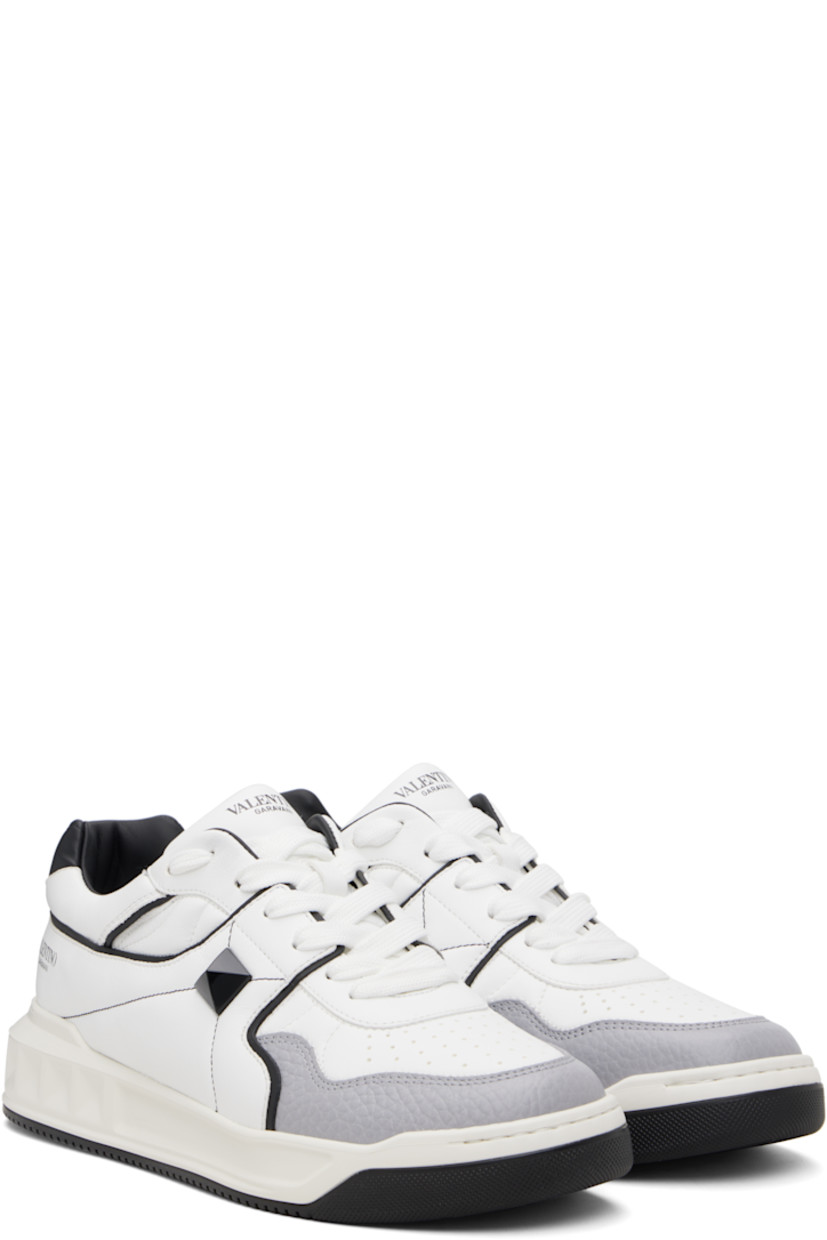 Low-top quilted nappa leather sneakers.

· Perforations at toe
· Lace-up closure
· Logo printed at padded tongue
· Padded collar
· Logo printed at outer side
· Signature pyramid stud at outer side
· Buffed leather and mesh lining
· Logo embossed at treaded rubber sole

Supplier color: White/Black/Grey