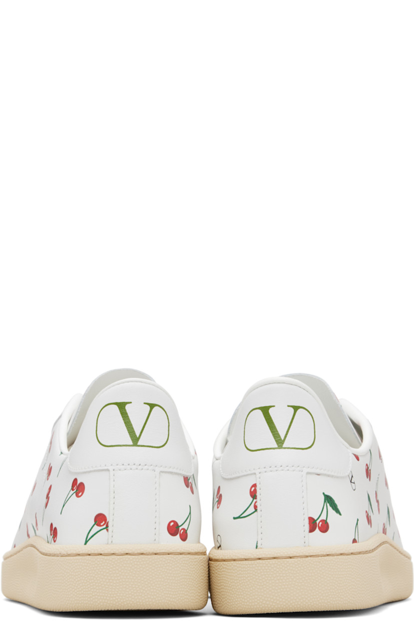 Low-top buffed calfskin sneakers. 

· Logo and graphic pattern printed throughout
· Logo hardware at vamp
· Lace-up closure
· Logo printed at heel tab
· Treaded rubber sole

Supplier color: White/Red