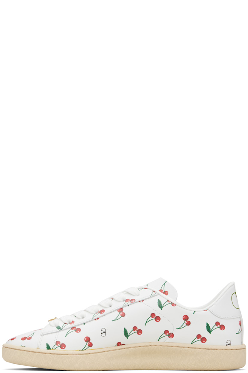 Low-top buffed calfskin sneakers. 

· Logo and graphic pattern printed throughout
· Logo hardware at vamp
· Lace-up closure
· Logo printed at heel tab
· Treaded rubber sole

Supplier color: White/Red