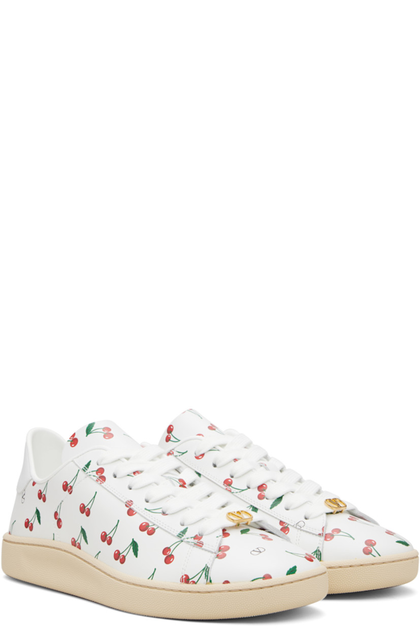 Low-top buffed calfskin sneakers. 

· Logo and graphic pattern printed throughout
· Logo hardware at vamp
· Lace-up closure
· Logo printed at heel tab
· Treaded rubber sole

Supplier color: White/Red