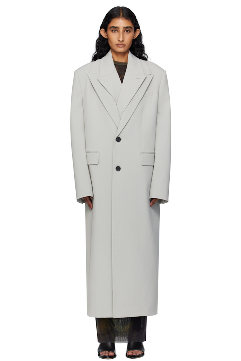 Stretch nylon gabardine coat.

· Layered construction
· Peaked lapels
· Double-breasted button closures
· Welt pocket at chest
· Flap pockets at waist
· Padded shoulders
· Buttoned surgeon's cuffs
· Locker loop at back collar
· Central vent at back hem
· Welt pockets at interior
· Full satin twill lining
· Logo-engraved horn hardware

Supplier color: Grey