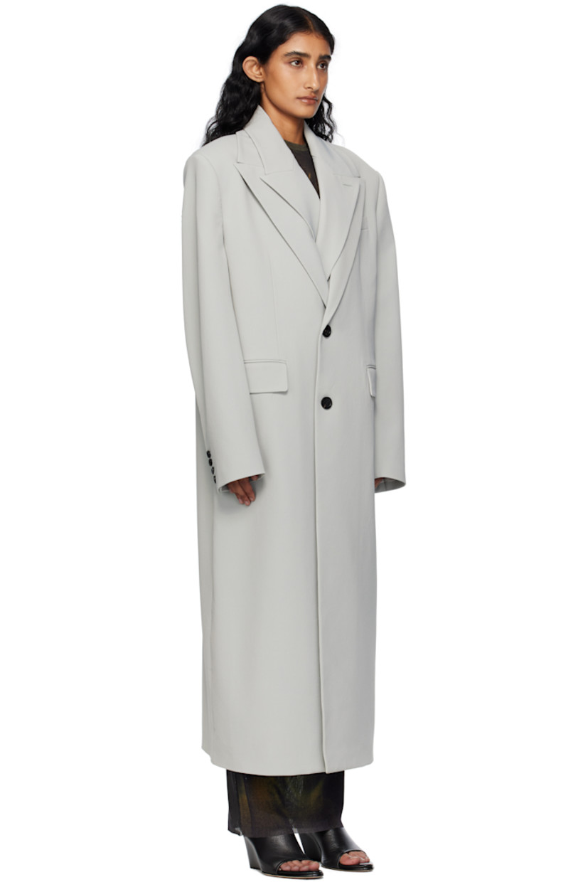 Stretch nylon gabardine coat.

· Layered construction
· Peaked lapels
· Double-breasted button closures
· Welt pocket at chest
· Flap pockets at waist
· Padded shoulders
· Buttoned surgeon's cuffs
· Locker loop at back collar
· Central vent at back hem
· Welt pockets at interior
· Full satin twill lining
· Logo-engraved horn hardware

Supplier color: Grey