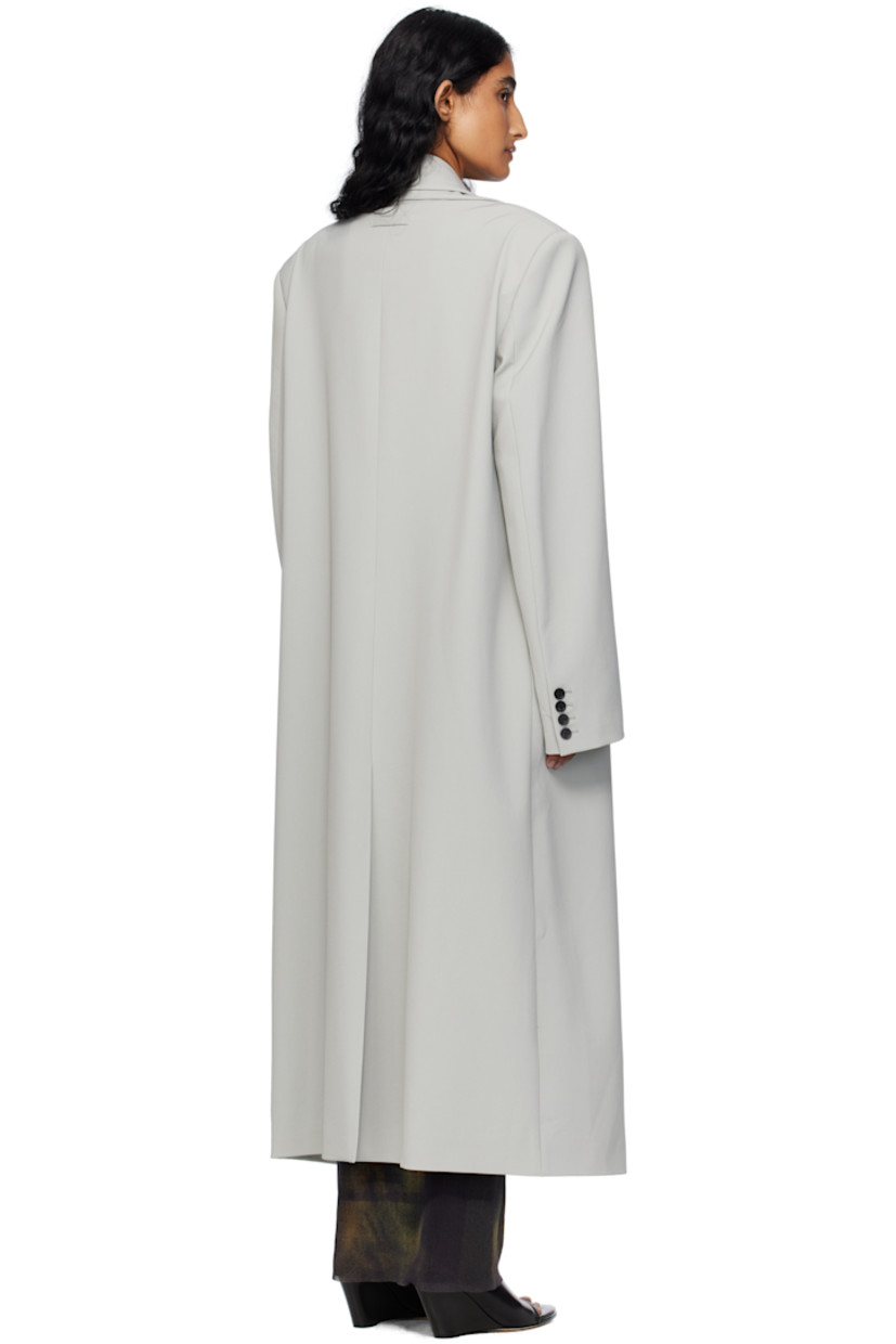 Stretch nylon gabardine coat.

· Layered construction
· Peaked lapels
· Double-breasted button closures
· Welt pocket at chest
· Flap pockets at waist
· Padded shoulders
· Buttoned surgeon's cuffs
· Locker loop at back collar
· Central vent at back hem
· Welt pockets at interior
· Full satin twill lining
· Logo-engraved horn hardware

Supplier color: Grey