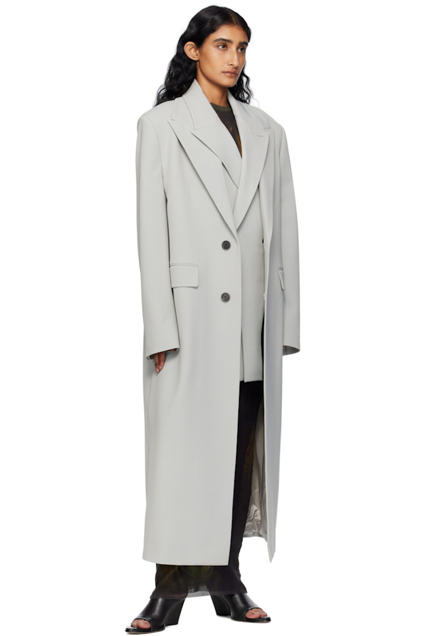 Stretch nylon gabardine coat.

· Layered construction
· Peaked lapels
· Double-breasted button closures
· Welt pocket at chest
· Flap pockets at waist
· Padded shoulders
· Buttoned surgeon's cuffs
· Locker loop at back collar
· Central vent at back hem
· Welt pockets at interior
· Full satin twill lining
· Logo-engraved horn hardware

Supplier color: Grey