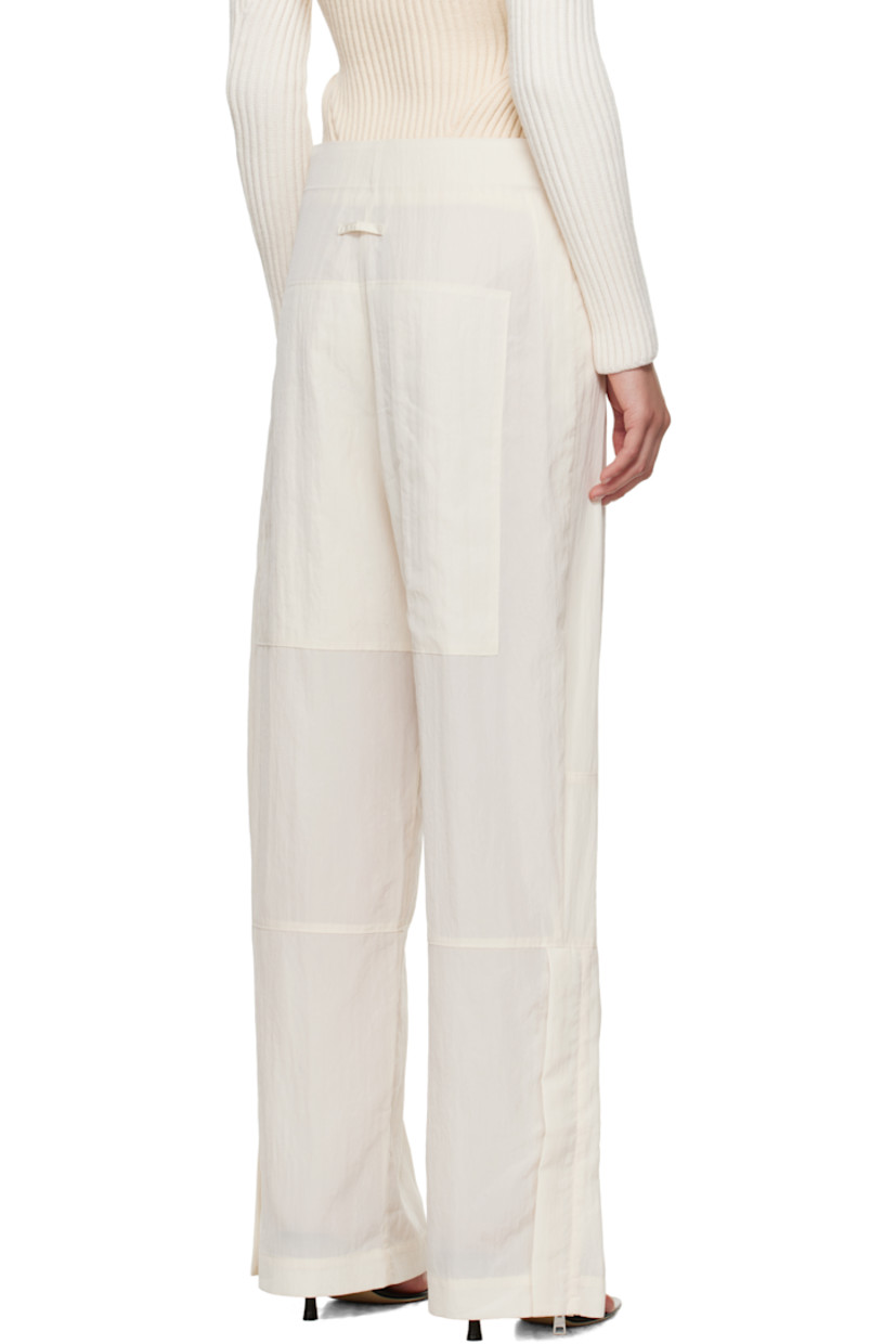 Crinkled lyocell-blend sateen trousers.

· Paneled construction
· Wide-leg
· Adjustable press-studs at waistband
· Zip pocket at front
· Zip vent at cuffs
· Locker loop at back waist
· Logo-engraved silver-tone hardware

Supplier color: Ecru