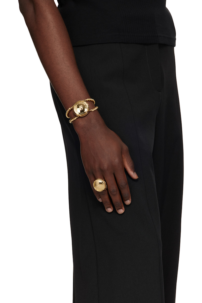Sculptural ring in gold-tone brass. 

· Twisted detailing throughout
· Logo engraved at face

Supplier color: Gold