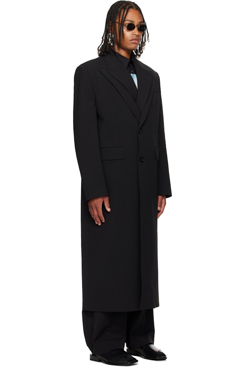 Stretch nylon gabardine coat.

· Layered construction
· Peaked lapels
· Double-breasted button closures
· Welt pocket at chest
· Flap pockets at waist
· Padded shoulders
· Buttoned surgeon's cuffs
· Locker loop at back collar
· Central vent at back hem
· Welt pockets at interior
· Full satin twill lining
· Logo-engraved horn hardware

Supplier color: Black