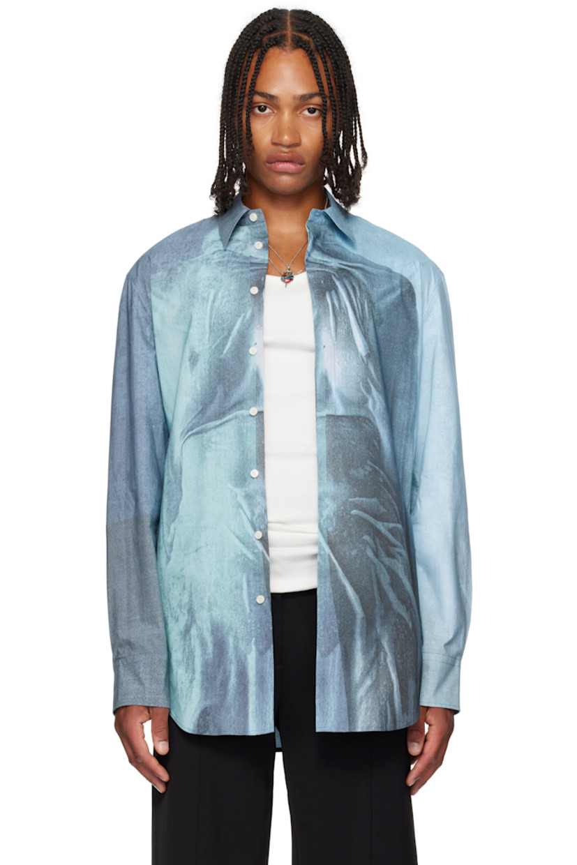 Stretch cotton poplin shirt.

· Trompe l'oeil graphic printed throughout
· Spread collar
· Button closure
· Shirttail hem
· Buttoned barrel cuffs
· Locker loop at back
· Mother-of-pearl hardware

Supplier color: Indigo