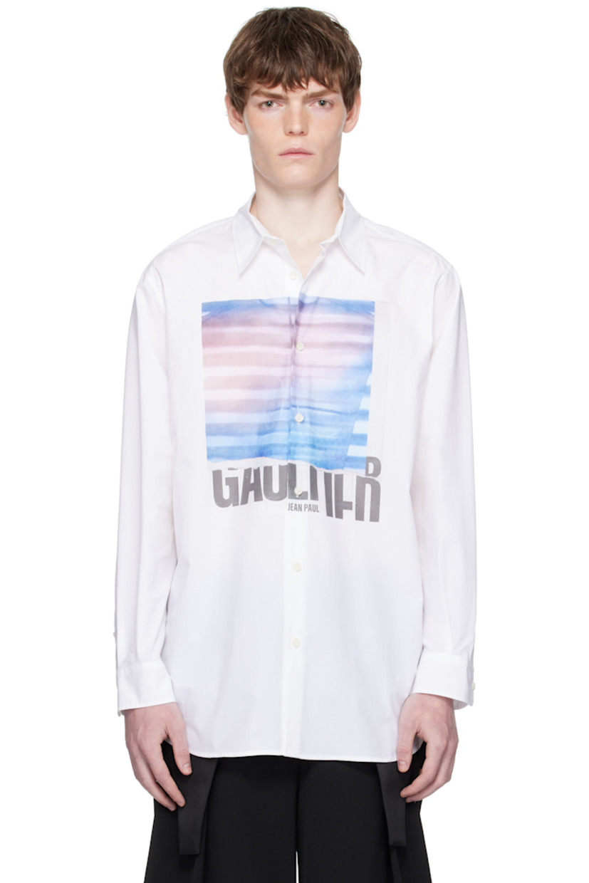 Cotton poplin shirt.

· Spread collar
· Button closure
· Logo graphic printed at front
· Droptail hem
· Buttoned barrel cuffs
· Locker loop at back collar
· Box pleat at back yoke
· Mother-of-pearl hardware

Supplier color: White