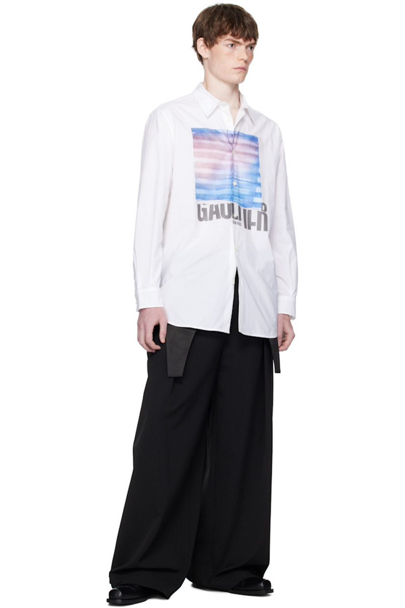 Cotton poplin shirt.

· Spread collar
· Button closure
· Logo graphic printed at front
· Droptail hem
· Buttoned barrel cuffs
· Locker loop at back collar
· Box pleat at back yoke
· Mother-of-pearl hardware

Supplier color: White