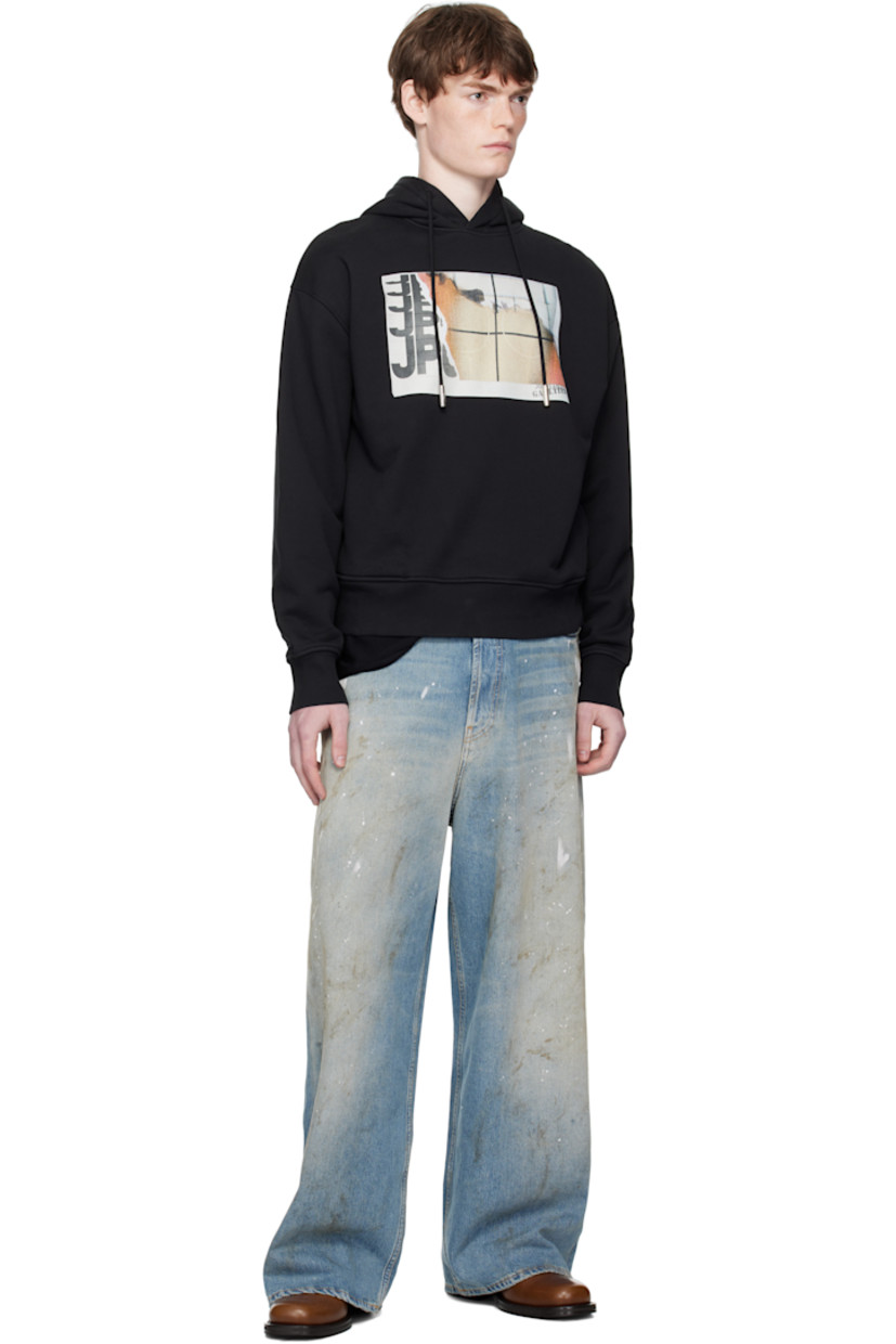 Cotton French terry hoodie.

· Drawstring at hood
· Logo graphic printed at chest
· Seam pockets at waist
· Rib-knit hem and cuffs
· Locker loop at back collar

Supplier color: Black/Orange