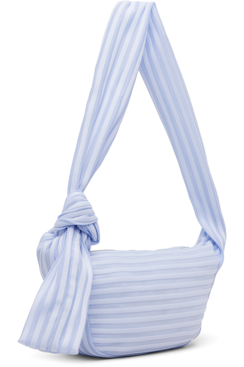 Technical knit shoulder bag.

· Semi-sheer ribbed stripes throughout
· Adjustable self-tie crossbody strap
· Zip closure
· Phone compartment at interior
· Unlined
· H6" x W11" x D3.5"

Supplier color: Nigella Blue