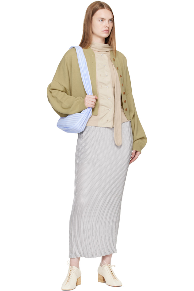 Technical knit shoulder bag.

· Semi-sheer ribbed stripes throughout
· Adjustable self-tie crossbody strap
· Zip closure
· Phone compartment at interior
· Unlined
· H6" x W11" x D3.5"

Supplier color: Nigella Blue