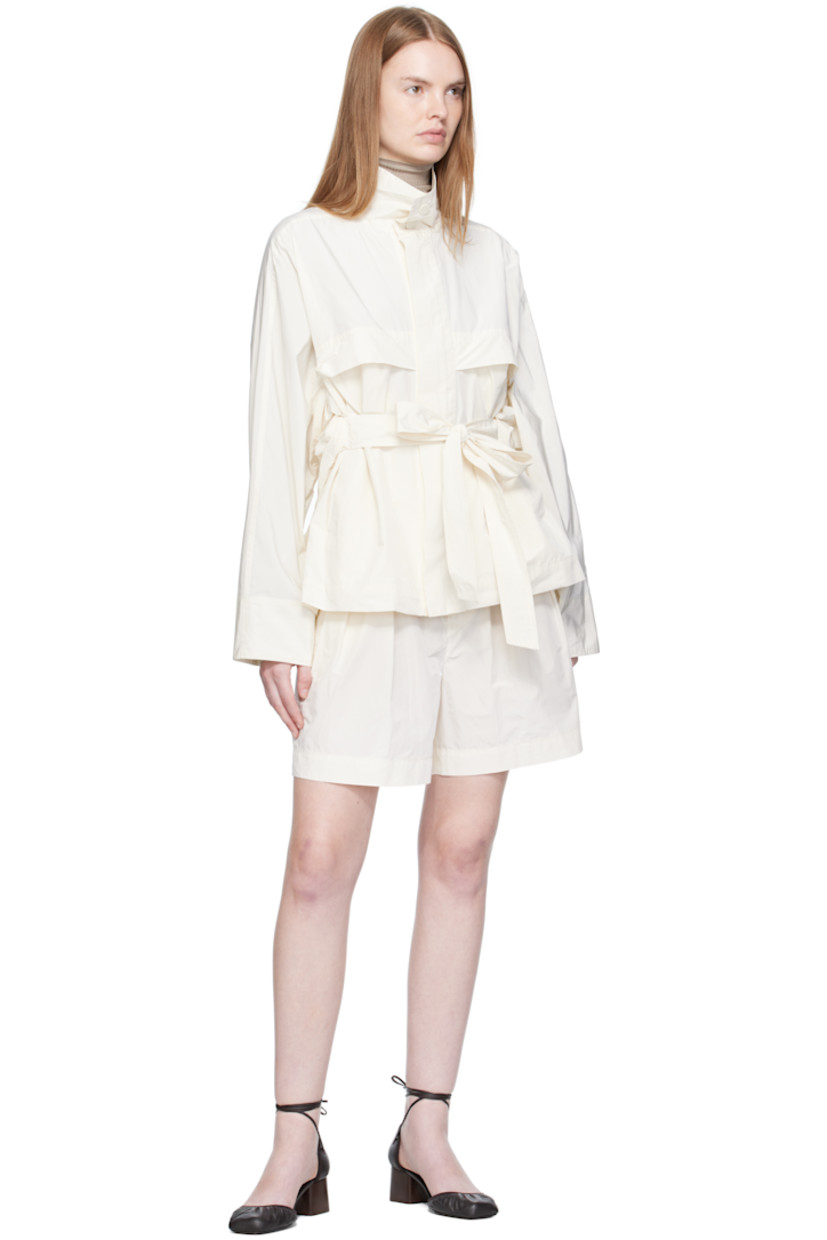Cotton-blend taffeta jacket.

· Press-stud fastening at stand collar
· Concealed zip closure
· Storm flap at chest and back
· Welt pockets at waist
· Integrated self-tie belt
· Yoke sleeves
· Adjustable press-stud fastening at back hem
· Unlined

Supplier color: Washi white