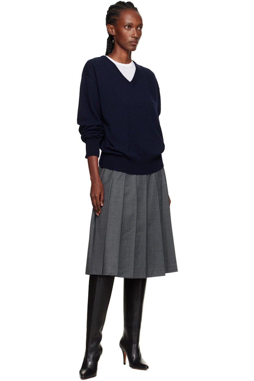 Wool-blend flannel midi skirt.

· Pleats throughout
· Two-pocket styling
· Button fastening and zip closure at side seam
· Full satin lining

Supplier color: Gray